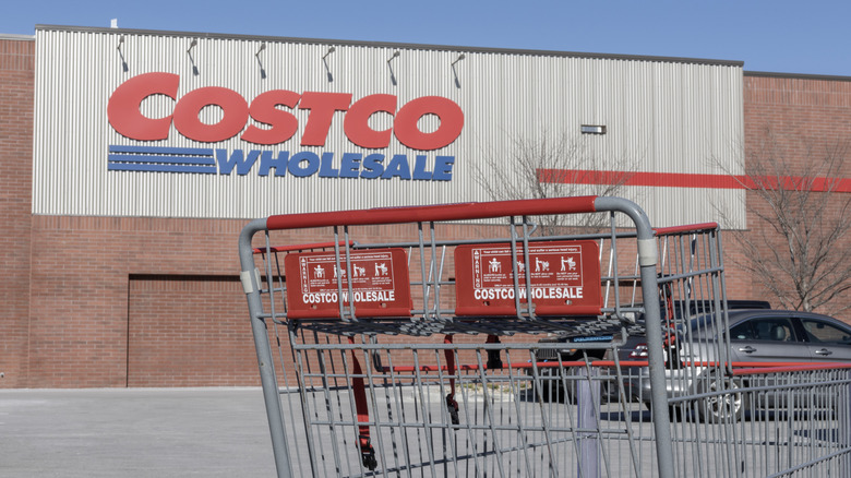 Exterior of a Costco with a shopping cart in the foreground