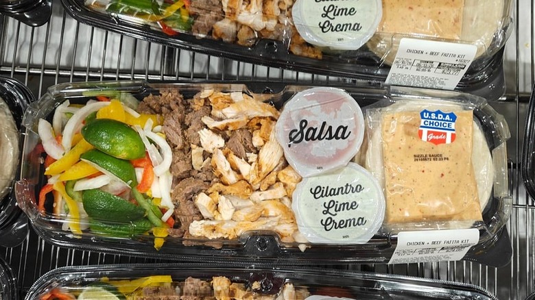 An image of Costco's fajita kits sitting in a grocery shopping cart.