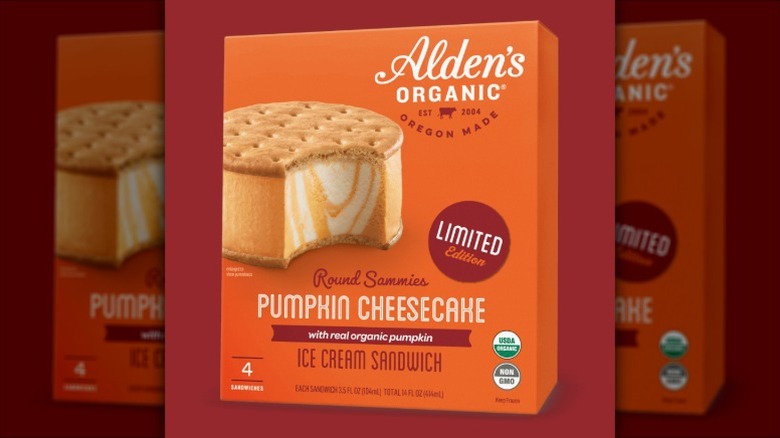 A box of Alden's Organic Pumpkin Cheesecake Ice Cream Sandwiches on a burgundy background.