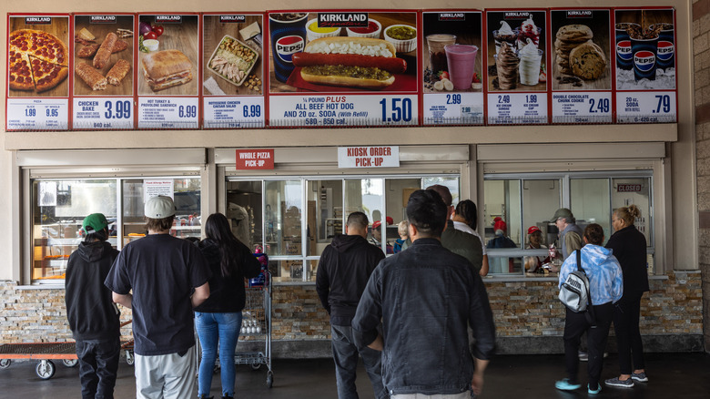 view of customers waiting at Costco food court and the menu that's hung on the wall