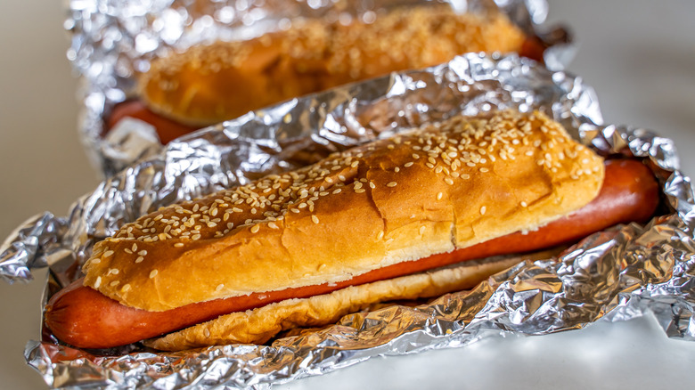 Two foil-wrapped Costco hot dogs