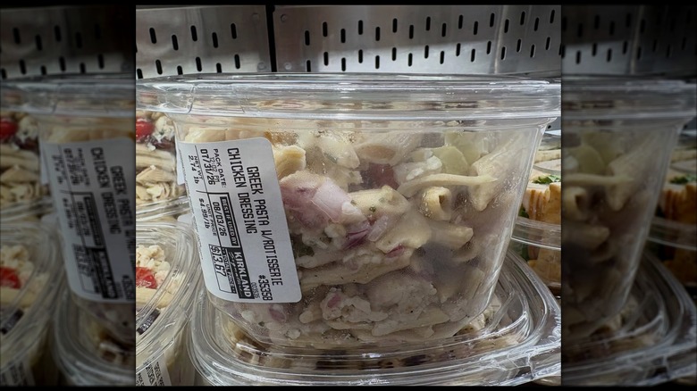 A close-up of a container of the Kirkland Signature Greek Pasta Salad with Rotisserie Chicken and Greek Dressing from Costco