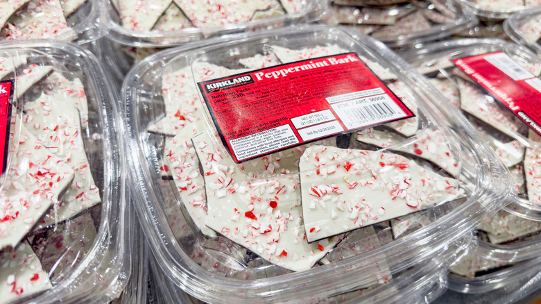 Containers of the Kirkland Signature Peppermint Bark sold in Costco's bakery section.