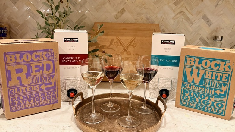 A tray of wine glasses filled with Costco and Trader Joe's boxed wines
