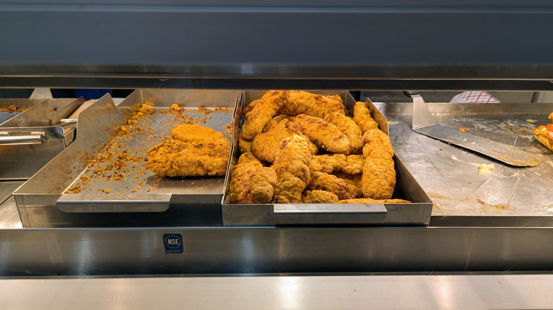 Chicken tenders under heat lamps in a Costco food court.