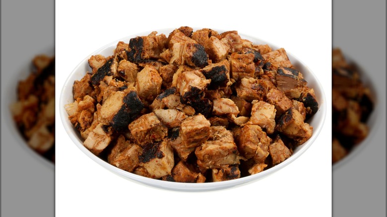Costco's Grilled Chipotle Seasoned Chicken in white bowl on white background