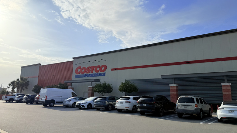Exterior shot of Costco location with cars in parking lot during the day