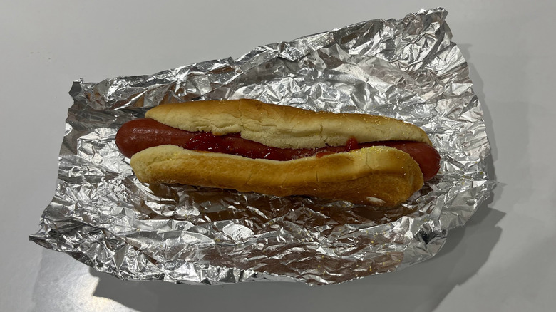 A hot dog on a bed of foil at the Costco food court