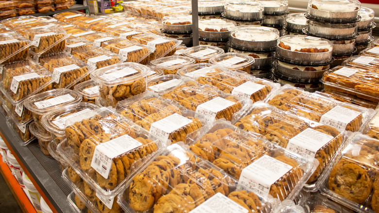 Costco baked goods section with cookie and cinnamon roll packages.