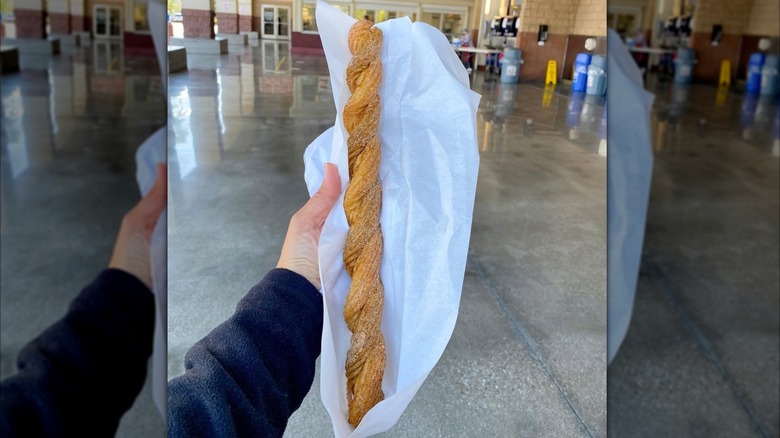 Hand holding Costco Twisted Churro