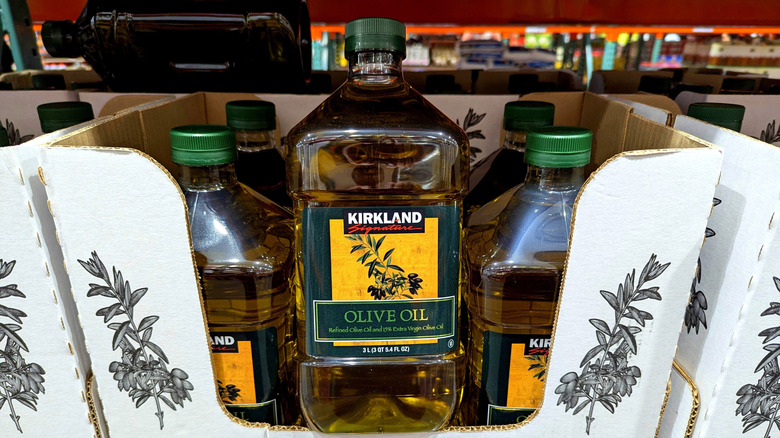 A large jug of Kirkland olive oil sits propped up in the aisle at Costco