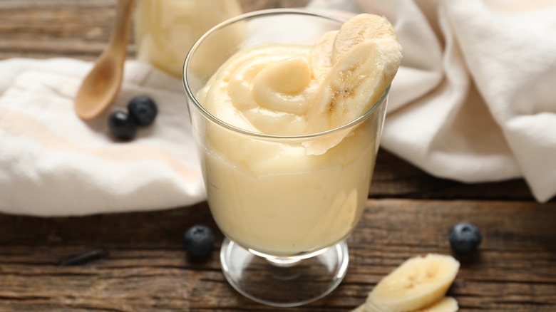 Glass of pudding with fresh banana slices