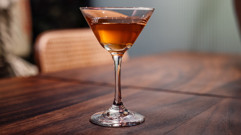 A spicy martini in a cocktail glass on a wooden table