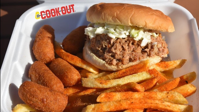 North Carolina barbecue sandwich tray with sides of French fries and hush puppies at Cook Out