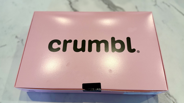Closed pink Crumbl box of cookies