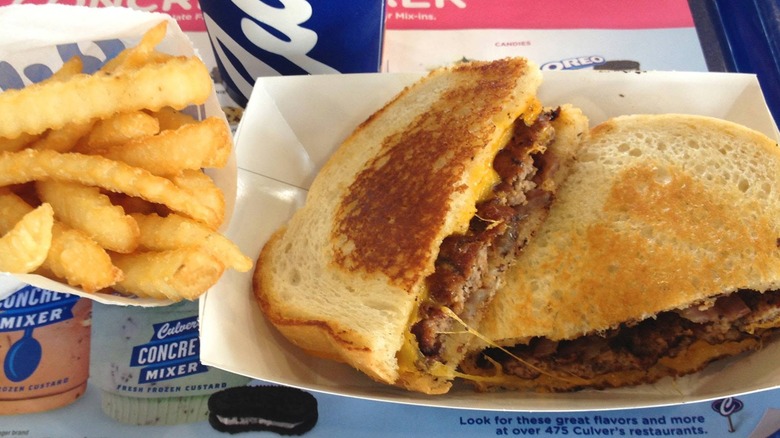 Culver's Sourdough Melt cut in half with a side of its crinkle cut fries.