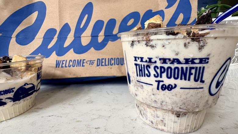 A Culver's bag with a two-scoop cup of Oreo Reese's Cheesecake frozen custard