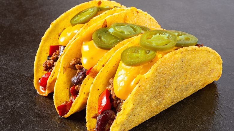 Three hard shell beef tacos.