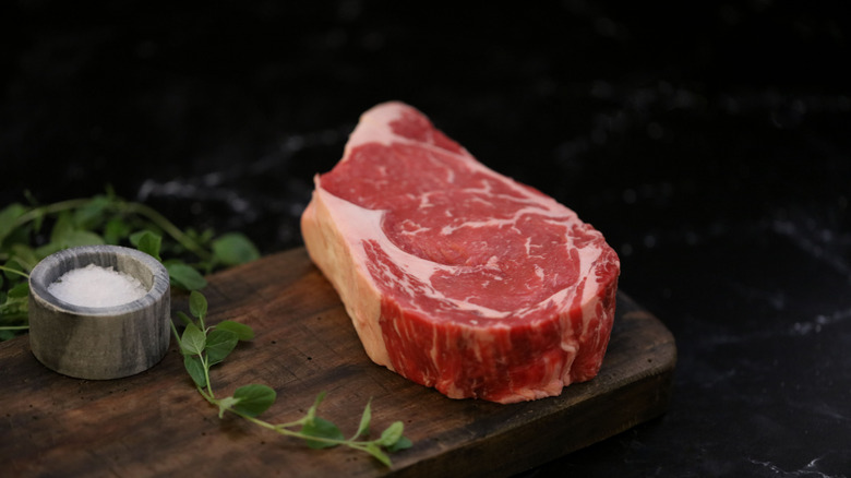 An uncooked thick Cut Angus Beef Ribeye Steak