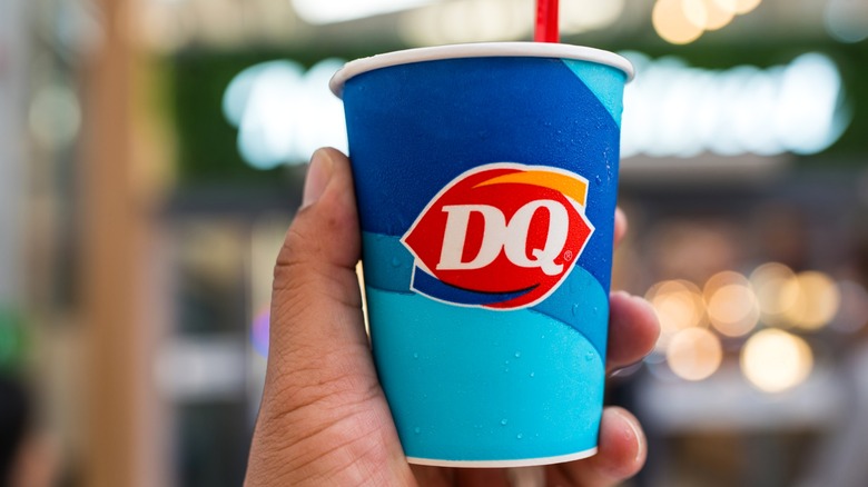 Person holding Dairy Queen cup with spoon