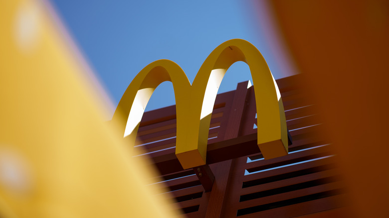 McDonald's Golden Arches on an exterior wall in front of blue sky