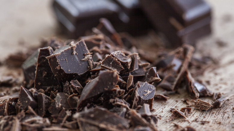 A close-up shot of a crumbled dark chocolate bar.