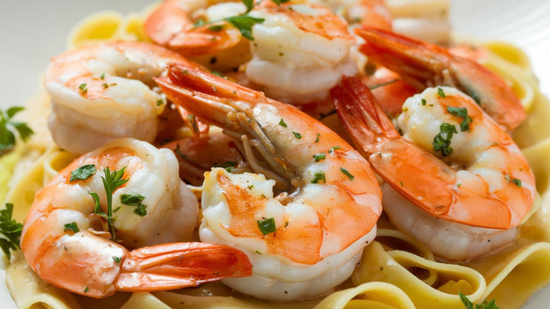 Close-up of cooked shrimp scampi on top of pasta noodles