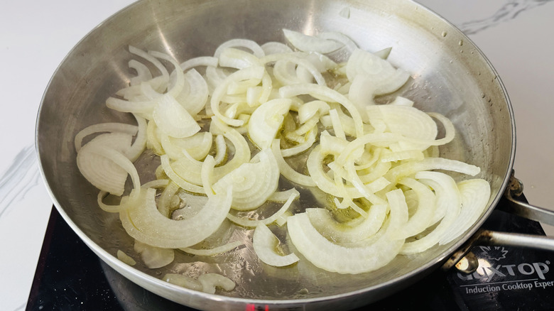 Sliced onions cooking in a saucepan