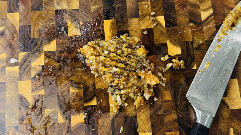 Caramelized onions chopped on a cutting board