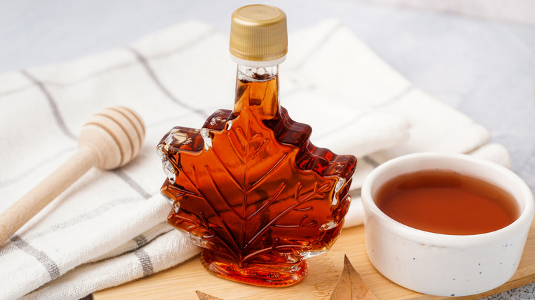 A leaf-shaped bottle of maple syrup and a bowl