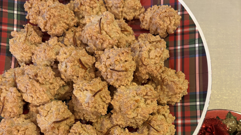 Plate of Brutti ma Buoni cookies on a festive green and white holiday plate