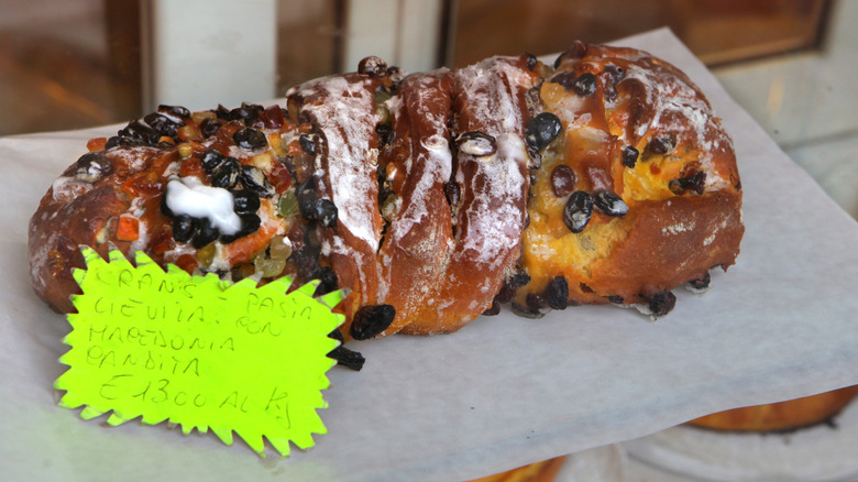 Bakery Log of Pizza Ebraica with candied fruit, nuts, glaze and a sign