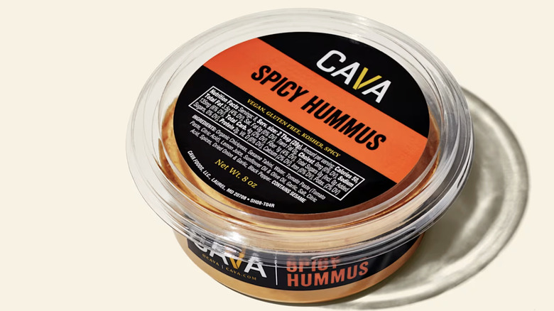 Small tub of Cava Spicy Hummus on neutral background