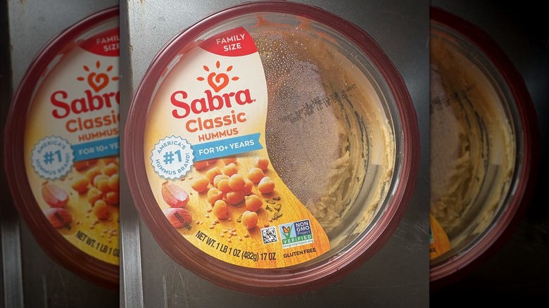 Top down view of small tub of Sabra Classic Hummus