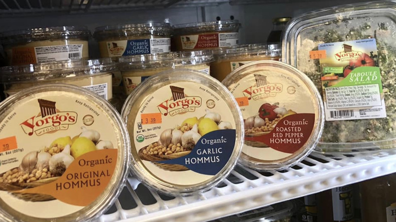Range of Yargo's hummuses and taboule salad on refrigerator shelf at store