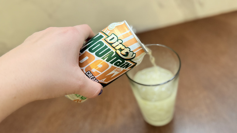 Pouring dirty mountain dew cream soda into glass