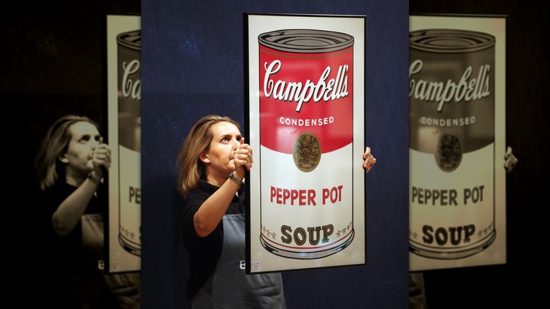 Woman holding Andy Warhol art of Pepper Pot soup