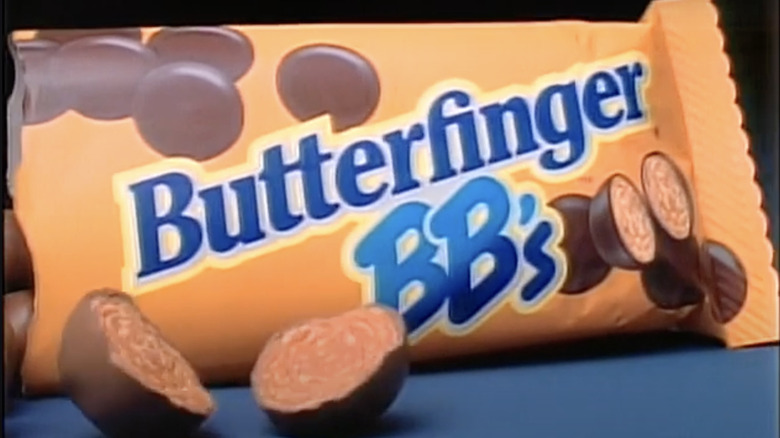 A bag of Butterfinger BB's with a halved BB candy showing the orange interior