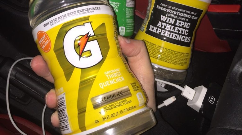 A photo of a hand holding a bottle of Gatorade Lemon Ice