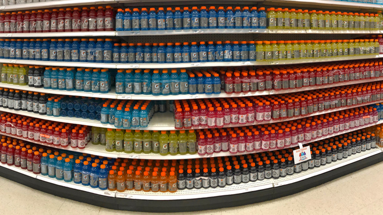 A stock photo of a store shelf filled with hundreds of bottles of Gatorade