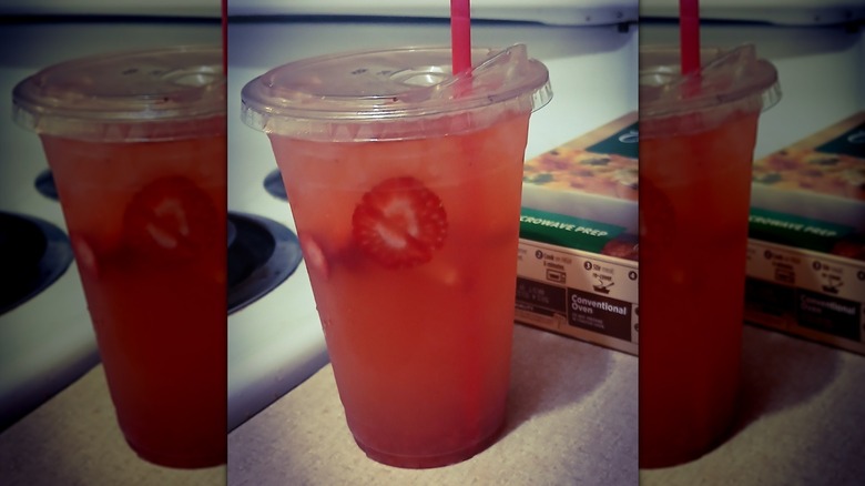 A cup of KFC Strawberry Lemonade with a straw
