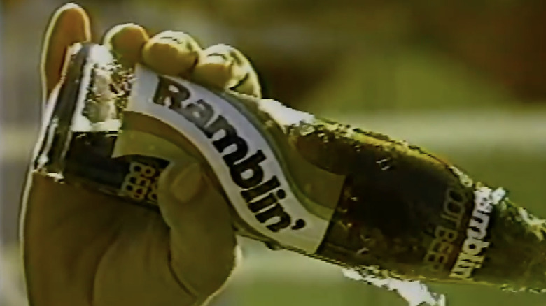 hand holding cold bottle of Ramblin' Root Beer in TV ad