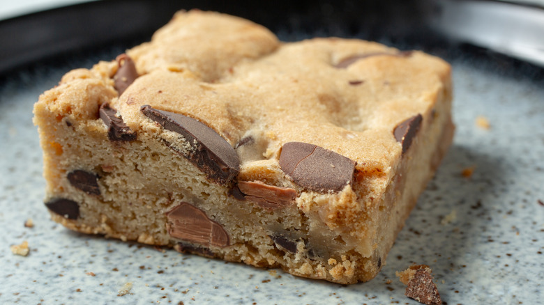 Close-up of blondie square with chunks of chocolate and toffee showing