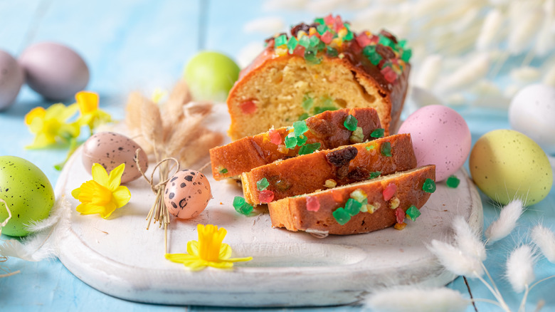 Fruitcake loaf and slices on serving tray by Easter decor