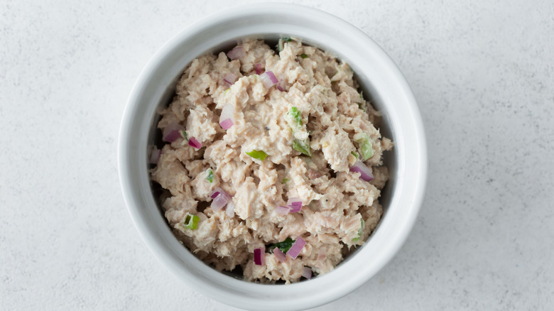 Tuna salad in white bowl on white countertop