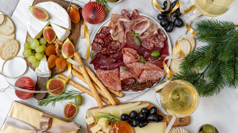Fancy charcuterie laid out on a white tablecloth