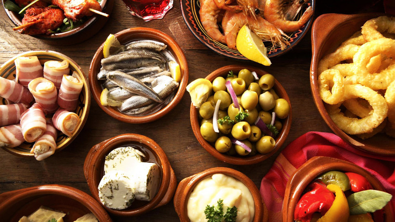 Assortment of bowls with Spanish snacks and foods