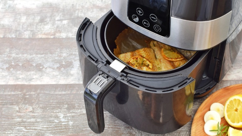 Fish being cooked in an air fryer.