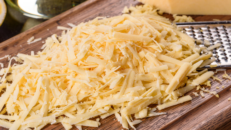 Grated cheese across a wood board.