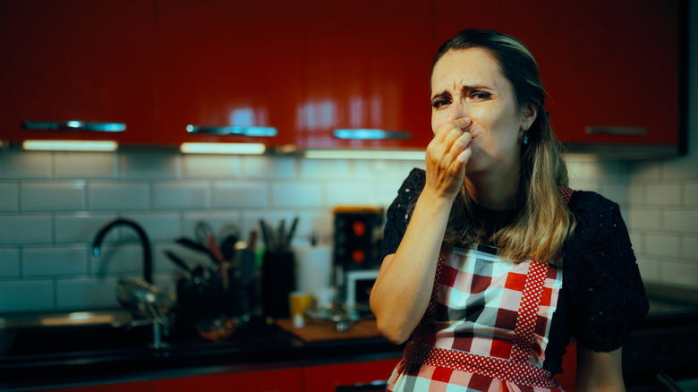 Person holding their nose